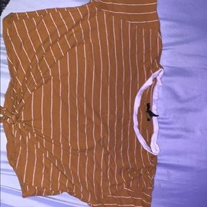 mustard cropped shirt with white striped and a not